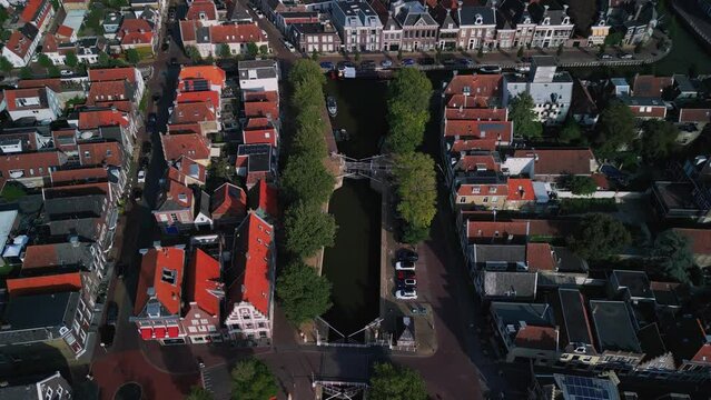 Aerial view of water in Harlingen Bay, boats, houses by the canal, villages on the North Sea with a yacht harbor, summer holidays in the Netherlands