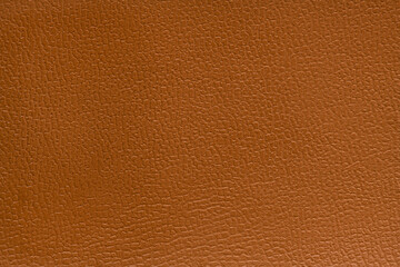 Brown artificial leather with large texture. Artificial skin. Close-up. Background. Texture.