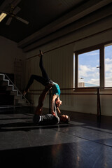 Couple of black boy and white girl in a class doing a training in ballet academy