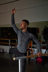 boy black dancer in a warm-up and dancing in a ballet class