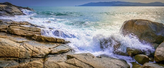 View of sea waves breaking rocky beach