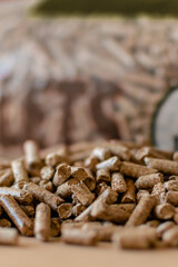 Pile of pellets with bag of granules in the background