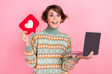 Photo of smm content maker young blog owner girl youtube creator heart button figure using netbook isolated on pink color background