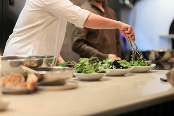Obraz na płótnie Canvas Chef preparing a healthy salad in a modern kitchen of the restaurant