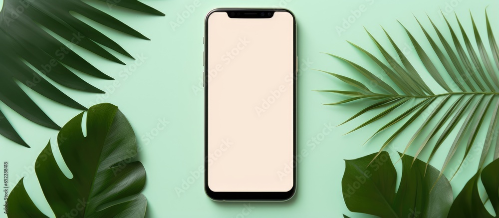 Poster top view of a black phone on green background displaying blank screen in a minimal summer style sett