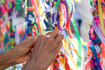 Catholics are seen tying ribbons on the railing of the Senhor do Bonfim church during an open mass in the city of Salvaldor, Bahia.