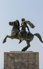 a statue of two men on horseback riding on a stone surface