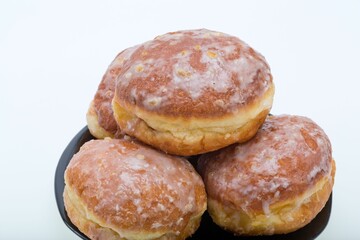 whole donuts on the black porcelain plate