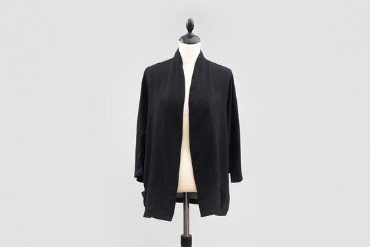 Black, simple jacket without buttons displayed on a headless mannequin