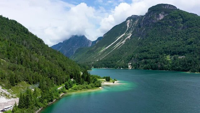 View to Julian Alps mountains above Predil lake in Italy with small lake. Predil Lake, Friuli Italy / (Lago del Predil), beautiful alpine lake in north Italy near the Slovenian border, Italy.