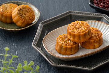 Delicious Cantonese moon cake for Mid-Autumn Festival food mooncake on blue table background.