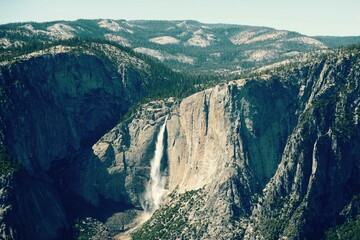 Aerial shot of Yosemite Falls Nature Preserve flowing down from a high rocky spot