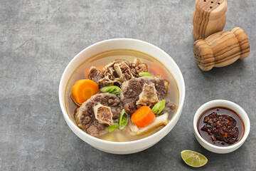 Sop Buntut or Oxtail Soup with carrot and potatoes. Indonesian traditional food

