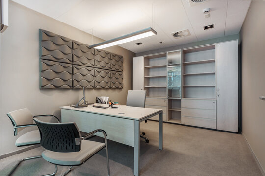 The interior of the office space in pastel colors with beige furniture.