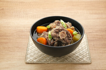 Sop Buntut or Oxtail Soup with carrot and potatoes. Indonesian traditional food
