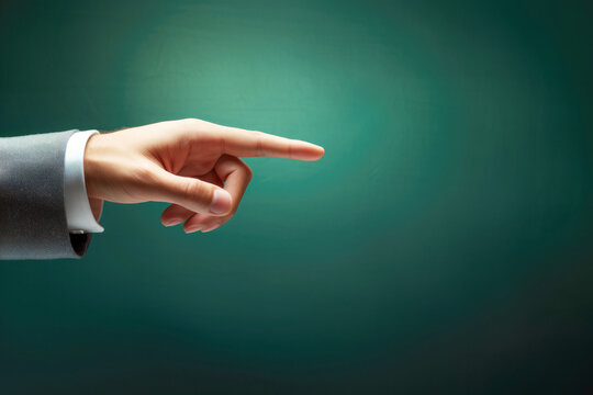 A man's hand makes a decisive pointing gesture, indicating a clear direction and purpose.