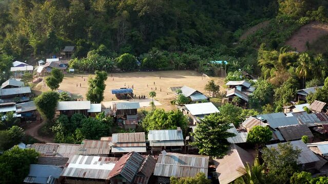 Longneck karen village in the mountain with football pitch or soccer field. Mae Hong Son, Thailand. Aerial Shot