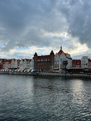 Naklejka premium Gdansk, Poland - 08.08.2022: Old town, view across the canal, dense houses.