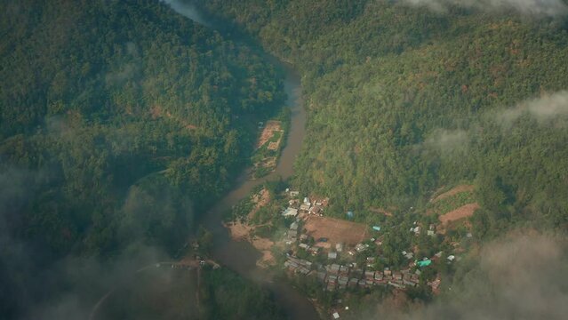 Longneck karen village in the mountain with clouds on the mountains. Mae Hong Son, Thailand. Aerial Shot