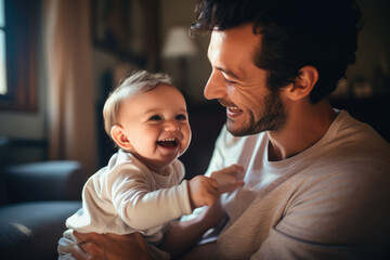 smiling loving dad with a cute happy baby at home