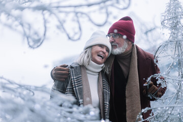 Fototapeta premium Senior couple walking in winter city center.