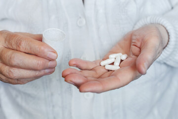 Medical capsules, pills in the hands, close-up
