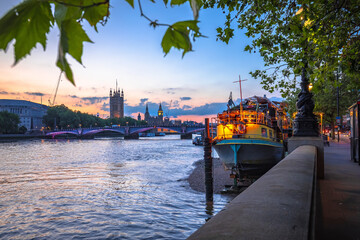 Westminster and Big Ben and Thames riverfront sundown view in London