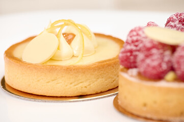 Closeup of lemon meringue tartlet, isolated on white background. View from above