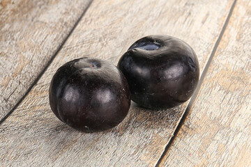 Two ripe sweet black plums