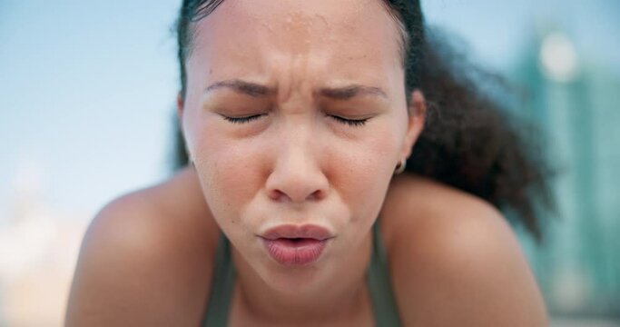 Sports, breathe and face of woman in the city for race, marathon or competition training. Fitness, rest and portrait of young female athlete runner sweating on a break for cardio workout in town.