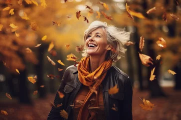 Fotobehang Photo of senior mature happy women in autumn forest © Kalim