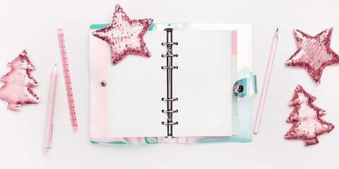 Open blank copybook, woman diary with colored gradient cover, Christmas decoration fir tree and star from sequins on white, banner. Concept of planning future goals and ideas for New Year