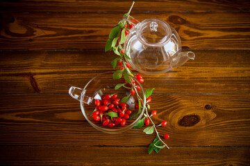 Branch with ripe red goji berry on wooden table