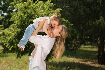 Obraz premium Happy mother with her daughter having fun in park