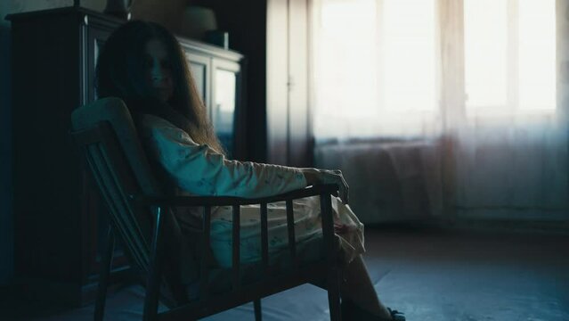 Creepy old woman in nightgown sitting in armchair, long messy hair, spooky ghost
