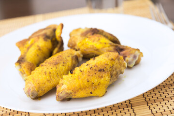 Fried chicken wings on white plate