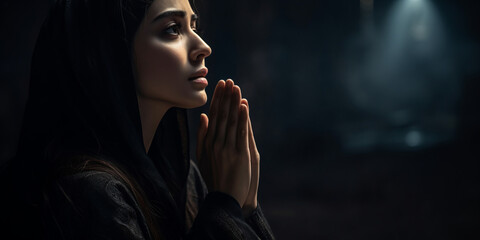 Side view of a woman praying at night, night mood with copy space