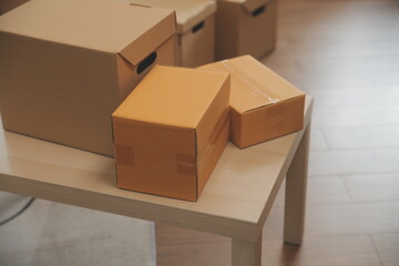 Beautiful young couple in love having fun unpacking things from cardboard boxes while moving in together in their new apartment