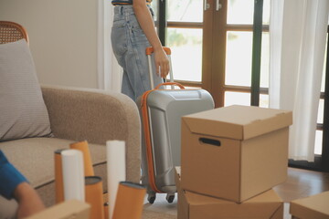 Beautiful young couple in love having fun unpacking things from cardboard boxes while moving in together in their new apartment