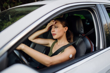 Woman with diabetes feeling dizzy during car drive.