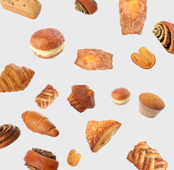 Aromatic fresh pastries falling on light grey background