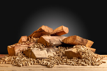 wood pellets and logs on a dark