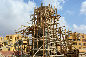A new mosque under construction, building a new grand Masjid mosque in Cairo, Egypt, with a big dome and high minaret, wooden scaffolds, Mosques are praying place for Muslims to perform their praying