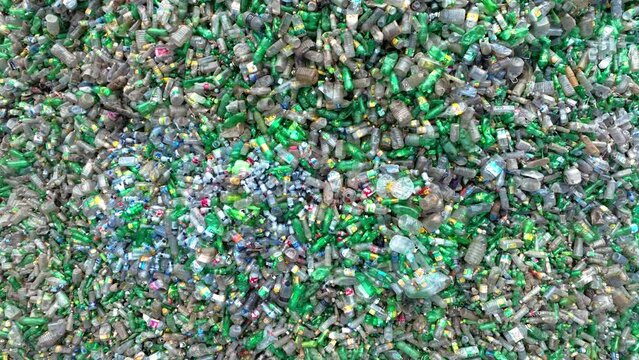Huge pile of plastic bottles in a plastic recycling factory. Plastic pollution crisis and the importance of recycling