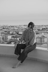 Beautiful girl on the balcony overlooking the sea