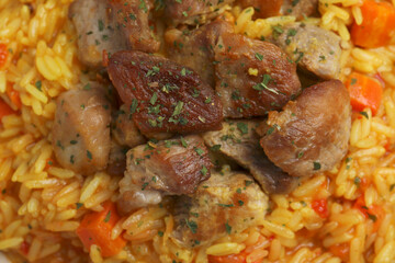 Delicious pilaf with meat as background, closeup