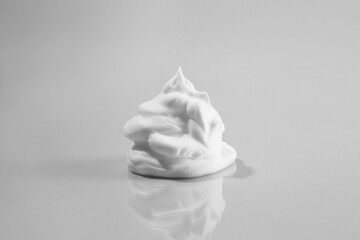 Sample of cleansing foam on light background. Cosmetic product