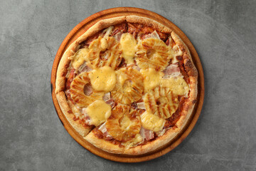 Delicious pineapple pizza on gray table, top view