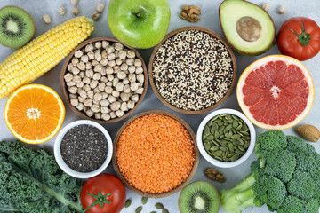 Healthy eating clean food selection: fruits, berries, vegetables, legumes, nuts on a gray background. Top view. 