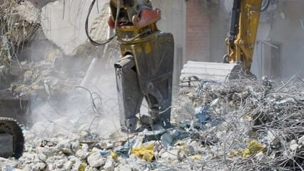 Process of dismantling the building. Equipment for engineering and construction services is in operation. Demolition of emergency buildings and removal of construction debris.